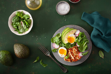 healthy keto paleo diet breakfast: boiled egg, avocado, halloumi cheese, salad leaves