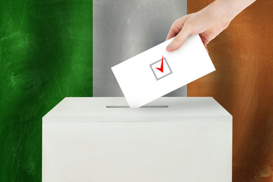 Ireland Vote Concept. Voter Hand Holding Ballot Paper For Election Vote On Polling Station