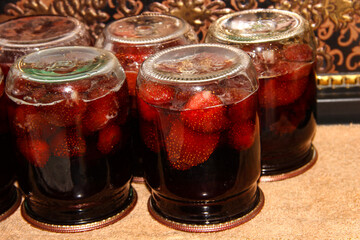 Fototapeta na wymiar Strawberry jam jars. Preparing food for the winter.