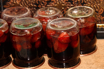 Fototapeta na wymiar Strawberry jam jars. Preparing food for the winter.