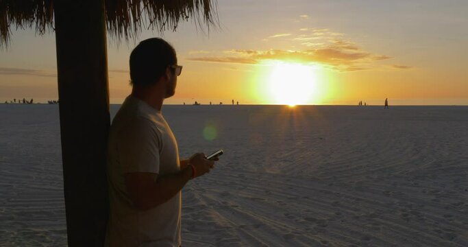 485 Person on his phone while looking into the sunset in Florida