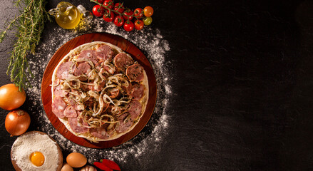 Various vegetables at wooden rustic background with copyspace on round pizza desk. Set of fresh vegetables. Egg, tomatoes, pepper, lettuce, onion, garlic, onion. Pizza ingredients.