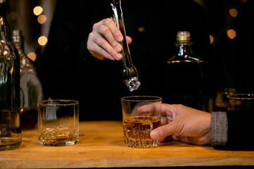 Barman pouring whiskey whiskey glass beautiful night