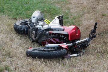 Fototapeta na wymiar Motorcycle bike accident broken and wrecked moto on grass..