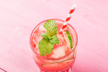 Watermelon summer cocktail with ice and mint leaves.