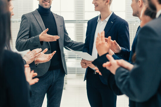 boss and business team congratulating their colleague