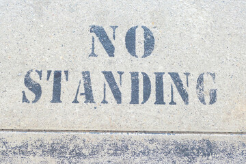 No standing sign painted on walkway