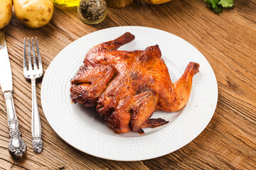 Fresh roast chicken on a wooden board background