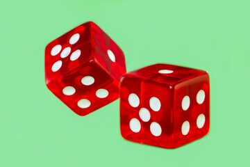 Two red dice on a green background. The game of poker.