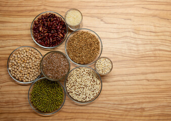 Cereals for proper nutrition on a wooden background, spelled on plates.
