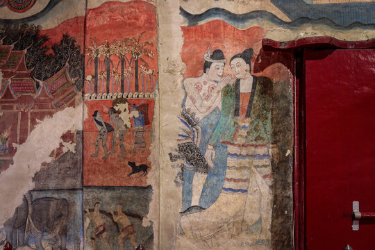 Ancient wall fresco painting, love whispering, in ordinance chapel at Wat Phumin. Famous tourist attraction and destination.