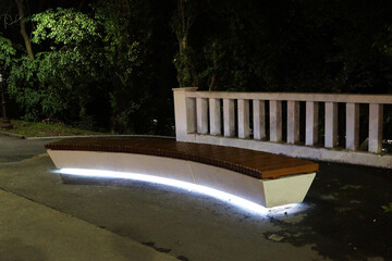 backlit bench at night in the park close up