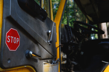 Fototapeta premium Stop sign on the car door. truck cab overlooking the steering wheel 