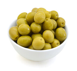 pickled green olives in a bowl and olive tree branch on a white background