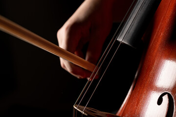 Close up macro photograph of a young cellist practicing
