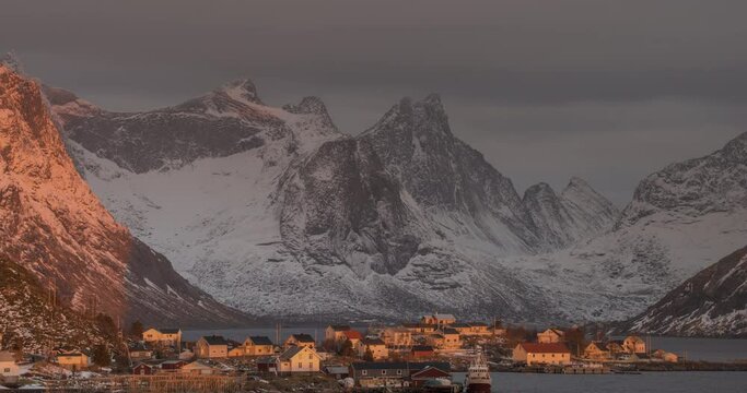4K, 10bit, YUV422 timelapse of  Reine Village with the sun shines on the fisherman's cabins in sunrise, Hamnoy, Lofoten Islands, Norway