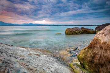 Fototapeta na wymiar Lake Garda, stones in the water