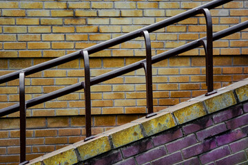Exterior cement profile of stairs and railings on brick wall background.