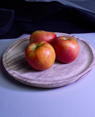 Apples on wooden plate