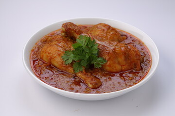 Chicken curry or masala,arranged in awhite bowl with white background