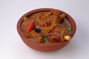 Mutton curry or Lamb curry,arranged in an earthenware with white background