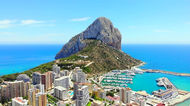 Aerial view Penyal d'Ifac Natural Park, Calpe townscape turquoise Mediterranean Sea,yachts at harbor. Province of Alicante, Costa Blanca Spain. Travel and landmark concept
