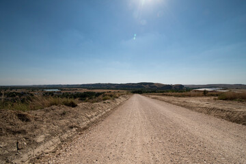 Fototapeta na wymiar dirt road with blue sky