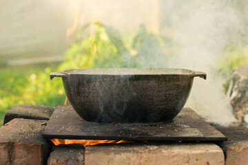 The cauldron on the fire. The pot on the fire.