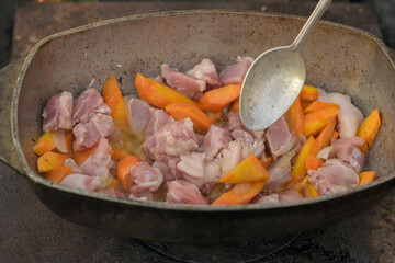 Pilaf in a cauldron with spoon