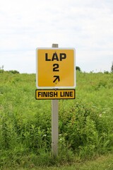 A close view of the yellow lap finish line sign.