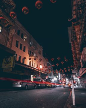 Lanterns Hanging In Illuminated City At Night