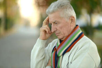Portrait of senior man thinking in park