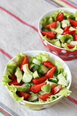 salad with strawberries, avocado, lettuce, green peas.