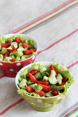 salad with strawberries, avocado, lettuce, green peas.