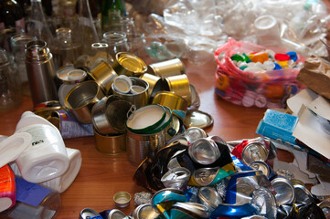 Waste sorting at home. Separate collection of household garbage. Preparation of waste for recycling: glass, plastic bags, metal, plastic, cardboard, aluminum. Waste management concept.