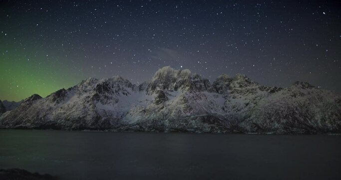 4K,10bit,422,timelapse video of night starry sky with northern light and snow mountain in Lofoten,Norway, beautiful dark day time, stars shining,  star trails rolling