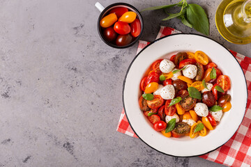 Traditional Caprese salad made of sliced fresh tomatoes, mozzarella cheese and basil