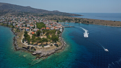 Aerial drone photo of picturesque fishing village of Perdika next to iconic small island of Moni,...