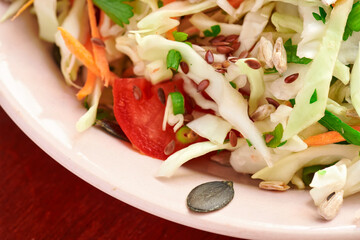 healthy food - fresh chopped vegetables on a wooden background, tomatoes and greens