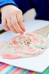 Drawing for children, little artists. Finger paints, free time for toddler. Ice cream cone made of recycled cardboard.