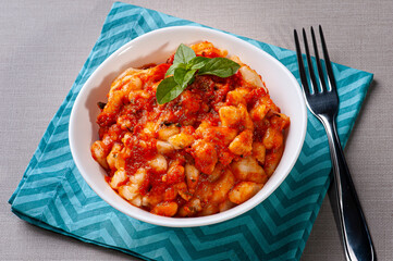 .Potato gnocchi with tomato and cheese sauce. Top view