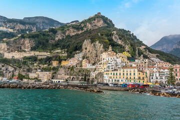 Fototapeta na wymiar The seaside town of Amalfi, Italy sits beneath high cliffs