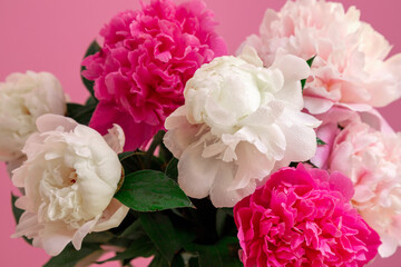 Bouquet beautiful flowers on pink background. Universal greeting card. FLatlay with pionies