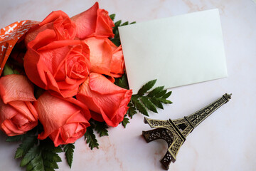 postcard mockup. beautiful bouquet of orange roses and an envelope. congratulation. invitation. flat lay