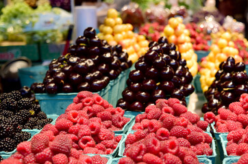 Raspberries and other berries nicely arranged for sale at the local Farmer's Market. 