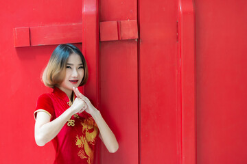 Portrait beautiful asian woman in Cheongsam dress,Thailand people,Happy Chinese new year concept,Happy  asian lady in chinese traditional dress