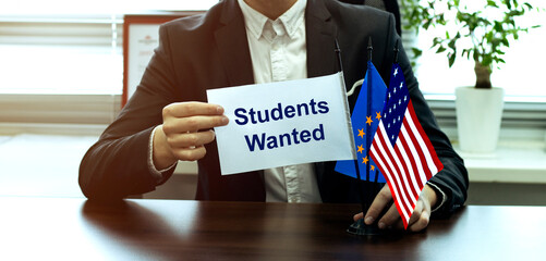 man take a flag with text Students Wanted with flags on the office background