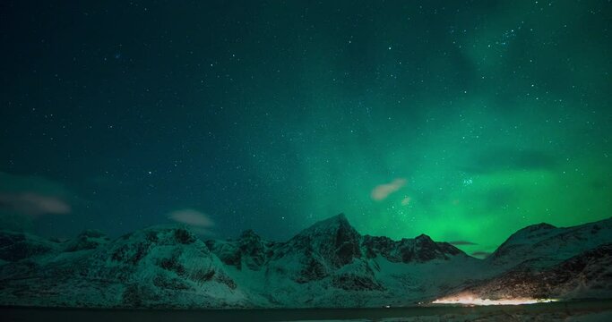 4K,10bit,422,timelapse video of night starry sky with northern light and snow mountain in Lofoten,Norway, northern light aurora shining 