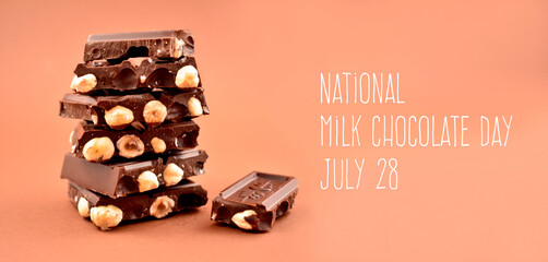 National Milk Chocolate Day stock images. Pile of Chocolate stock images. Nut chocolate on a brown background. Chocolate cubes on heap images. Milk Chocolate Day Poster, July 28. Important day