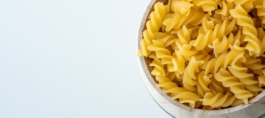 Raw dry uncooked Fusilli pasta spaghetti noodle on white background Good for basil tomato pesto sauce Homemade fresh Italian food organic whole wheat vegan spaghetti noodle for a healthy meal